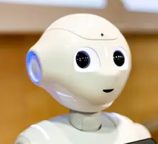 Pepper - the japanese semi humanoid robot assistant closeup on face / head, portrait . Artificial intelligence, modern human like robotics concept