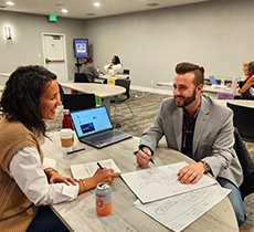 Composite image of build website interface against graphic designers working at desk in the office