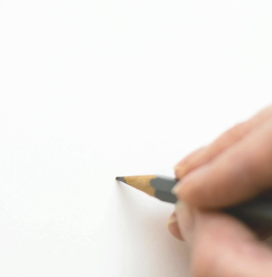 A person points at a computer screen displaying a website editor with "Welcome to my Website" text and navigation buttons.